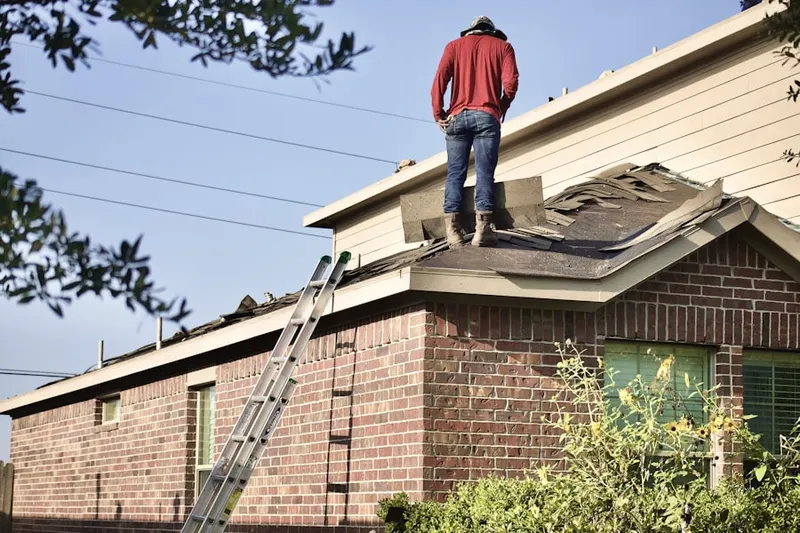 Professional roofer working on a residential roof in Mount Carmel Center